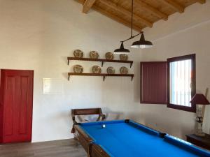 a room with a pool table and a red door at Monte do Pombal in Sousel