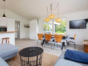 a living room with a dining room table and chairs at 6 person holiday home in Karreb ksminde in Karrebæksminde