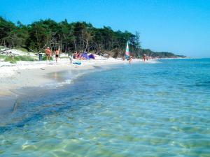 a group of people on a beach with the water at 14 person holiday home in Nex in Snogebæk