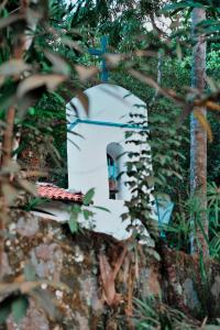 a small building in the middle of some trees at Vila Siriúba Hotel in Ilhabela