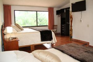 Lova arba lovos apgyvendinimo įstaigoje Hotel Quinta del Sol