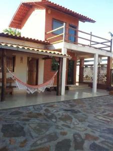 a house with a clothesline in front of it at Pousada Central in Santana do Riacho