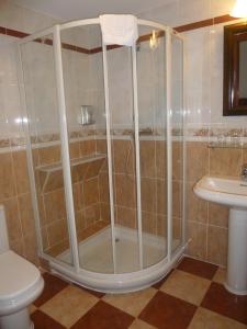 a shower in a bathroom with a toilet and a sink at Hotel Leku Eder in San Sebastián