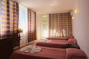 A bed or beds in a room at Sunny Varshava Hotel