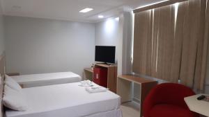 Katil atau katil-katil dalam bilik di Hotel Coimbra