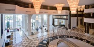 a lobby of a building with chandeliers at Juju Premier Palace Hotel Ex Amara Premier Palace in Beldibi