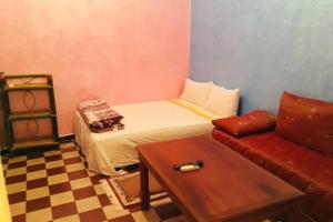 a small room with a bed and a couch at Nice 2 Bedrooms Apartment near the beach in Rabat