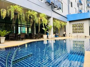 a swimming pool in front of a building at Mantra Varee Hotel in Khon Kaen
