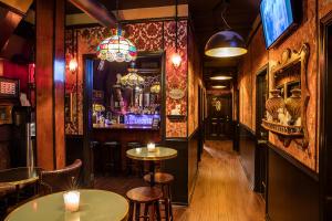 a bar with tables and chairs in a pub at The Rosemary in Los Angeles