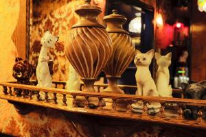 a shelf with some vases and cats on it at The Rosemary in Los Angeles