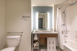 a bathroom with a toilet, sink, and bathtub at EVEN Hotel Atlanta - Cobb Galleria, an IHG Hotel in Atlanta