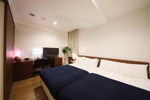 Postel nebo postele na pokoji v ubytování ZONK HOTEL Hakata