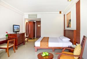 A bed or beds in a room at The Rani Hotel & Spa