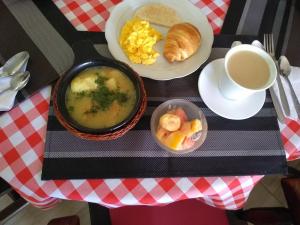 a table with a plate of soup and a cup of coffee at Mi Casa, Tu Casa-Hostal Tunja-Boyaca in Santa Rosa de Viterbo