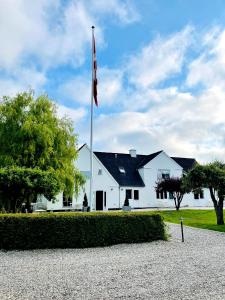 a flag pole in front of a white building at Egn Boutique Hotel in Stege