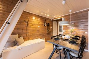a dining room with wooden walls and a table at UnelmaHelmi in Ruka