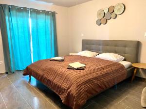 a bedroom with a large bed with blue curtains at Balkon Apartmanház Panzió in Balatonfüred