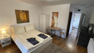 a bedroom with a bed with two bags on it at CITY Apartman in Balatonföldvár