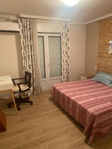 a bedroom with a bed and a desk and a table at BUNGALOW LA ISLA in Jávea +24 photos
