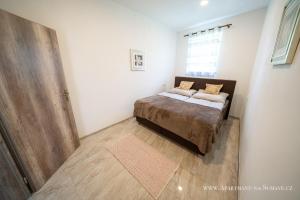 Posteľ alebo postele v izbe v ubytovaní Apartmány na Šumavě