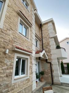 a facade of a building with white windows at 42° North Apartments in Tivat