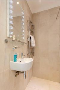 a bathroom with a sink and a mirror at Rose Mews Central Broadstairs in Kent +34 photos