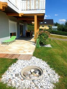 a patio with a fire pit in the yard at Ferienwohnung Albert Egger in Nötsch