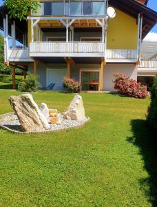 a building with a statue in front of a yard at Ferienwohnung Albert Egger in Nötsch