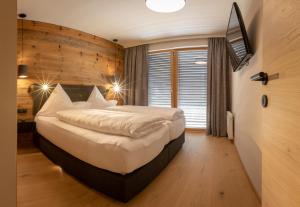 Un dormitorio con una cama grande y una ventana en Sport Apart en Zell am Ziller