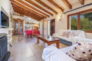 a living room with a couch and a table at Finca Can Solivellas in Pollença