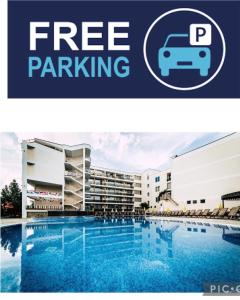 a picture of the free parking sign next to a swimming pool at Hotel Golden Dune in Sunny Beach