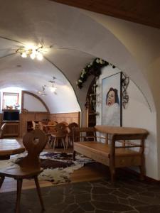 a living room with a bench and a table at Hotel Salvanel in Cavalese