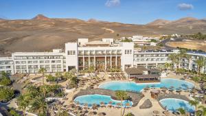 an aerial view of a resort with two swimming pools at Secrets Lanzarote Resort & Spa - Adults Only (+18) in Puerto Calero