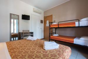 a bedroom with two bunk beds with towels on them at Hotel Consul - Family Hotel in Riccione