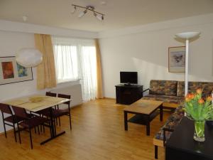 a living room with a couch and a table at Appartements Margot in Krumpendorf am Wörthersee