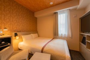 Postel nebo postele na pokoji v ubytování Tosei Hotel Cocone Asakusa