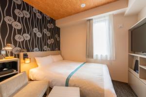 Postel nebo postele na pokoji v ubytování Tosei Hotel Cocone Asakusa