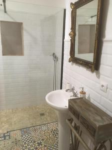 a bathroom with a sink and a mirror at El Molino del Corcho in Cazalla de la Sierra