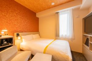 Postel nebo postele na pokoji v ubytování Tosei Hotel Cocone Asakusa