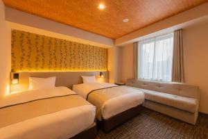 Postel nebo postele na pokoji v ubytování Tosei Hotel Cocone Asakusa