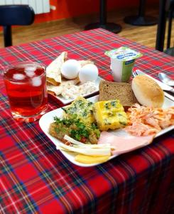 a table with a plate of food on a table at City Centre Hotel By Picnic in Yerevan