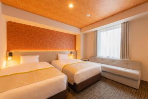 Postel nebo postele na pokoji v ubytování Tosei Hotel Cocone Asakusa