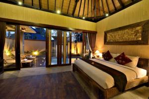 a bedroom with a large bed and a patio at Gino Feruci Villa Ubud by KAGUM Hotels in Ubud +45 photos