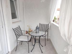 uma mesa e cadeiras numa varanda com uma janela em Holiday Home Mediterranean Dream em Vodice