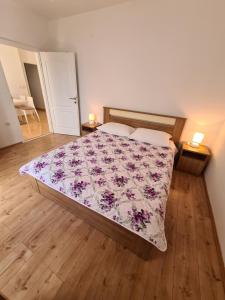 a bedroom with a bed with a floral bedspread at Guesthouse Marko in Povljana