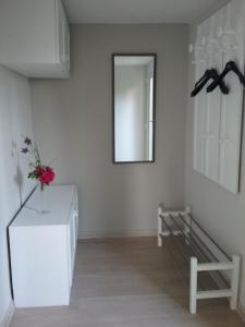 a white room with a mirror and a table at Haus Pollak in Waldkirchen