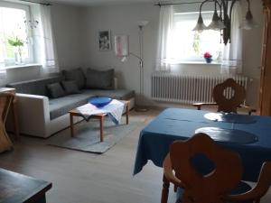 un soggiorno con tavolo blu e divano di Haus Pollak a Waldkirchen