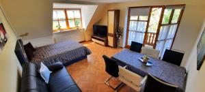 a living room with a bed and a dining table at Ferienwohnung/ Ferienresidenze Manuela in Obertrubach