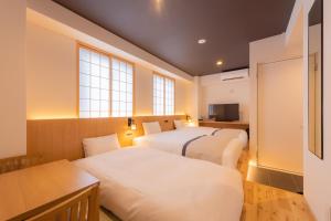 Postel nebo postele na pokoji v ubytování Tosei Hotel Cocone Asakusa