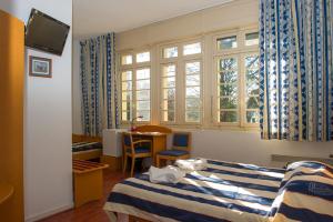 a hotel room with two beds and a window at VTF Le Domaine de Françon in Biarritz